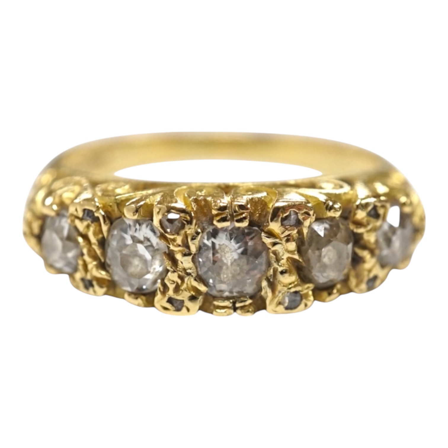 A modern Victorian style 18ct gold and graduated five stone diamond set half hoop ring, with rose set diamond chip set spacers, size Q, gross weight 7.1 grams. Condition - fair to good